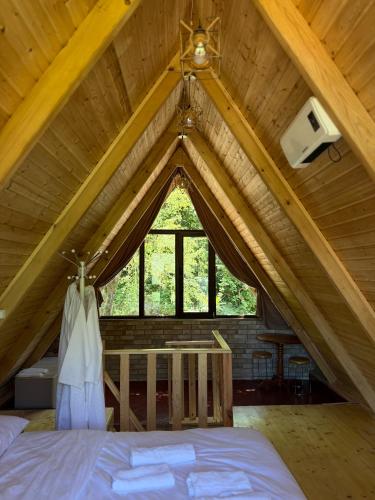 a room with a bed in a attic at Guri's hut in Kirnat'i