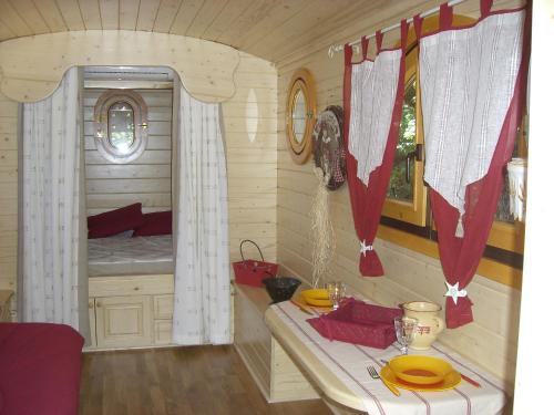 a small room with a bed in a cabin at Rêve de roulotte in Apt