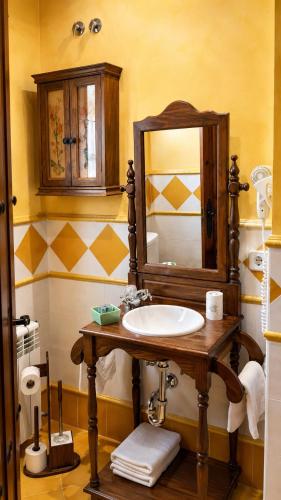 a bathroom with a sink and a mirror at Posada La Vieja Escuela Valles Pasiegos in San Roque de Ríomiera