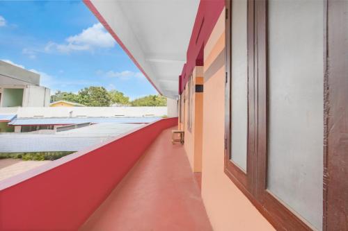 an empty corridor of a school building with a window at Hotel O SSR residency in Venjāramūdu