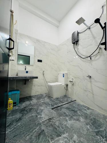 a bathroom with a toilet and a sink at Villa Calista Weligama in Weligama