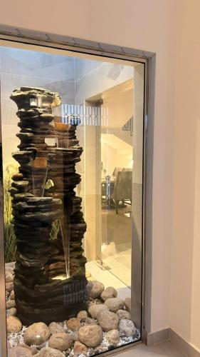 a mirror with a pile of rocks in a room at منزل لافيدا La Vida Home in Salalah
