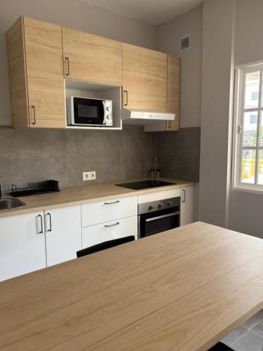 a kitchen with white cabinets and a wooden counter top at El Volcan in Los Llanillos
