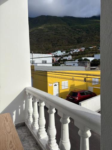 a balcony with a view of a yellow building at El Volcan in Los Llanillos