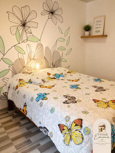 a bedroom with a bed with butterflies on it at Donde Emma in Salamina