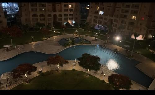 an overhead view of a swimming pool at night at Marina Valley El Alamein in El Alamein
