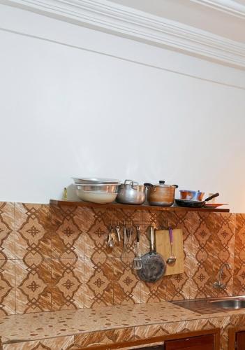 a kitchen with pots and pans on a counter at BKSF Wemtenga 1 in Ouagadougou