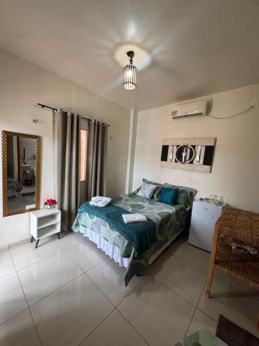 a bedroom with a bed and a mirror at Solar DorisMar in Luis Correia