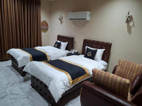 a hotel room with two beds and a couch at HOTEL STATE RESIDENCY in Bahawalpur