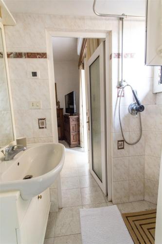a bathroom with a tub and a sink and a shower at Brezza dell'Argentario in Porto Santo Stefano