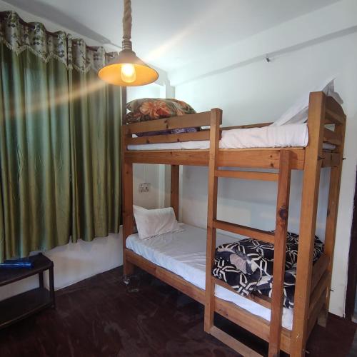 a bedroom with two bunk beds in a room at Bunkar house in Tosh