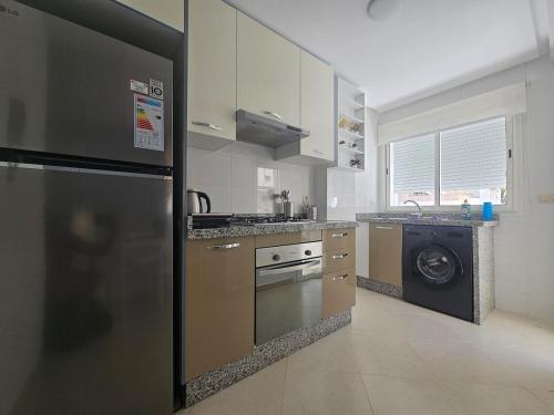 a kitchen with a stainless steel refrigerator and a dishwasher at Le Diamant in Tétouan