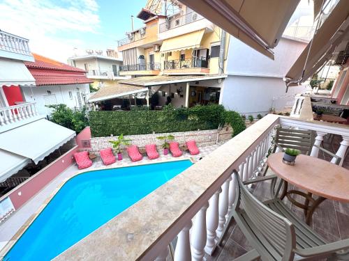 a balcony with a swimming pool and a table and chairs at Villa Antonis in Parga