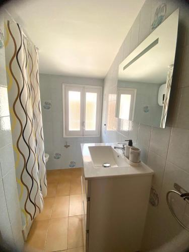 a bathroom with a sink and a mirror at Ca Muns Pares in Ginestar