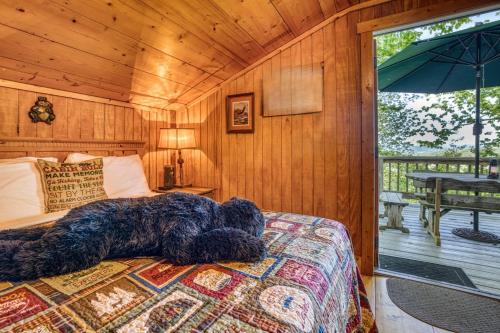 a large dog laying on a bed in a bedroom at Spectacular Mountain View - Cloud 9 - HotTub-PETS OK in Cleveland
