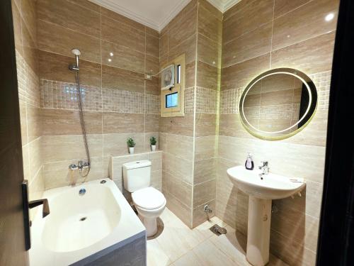 a bathroom with a sink toilet and a mirror at Rahaf palm beach chalet in Ain Sokhna