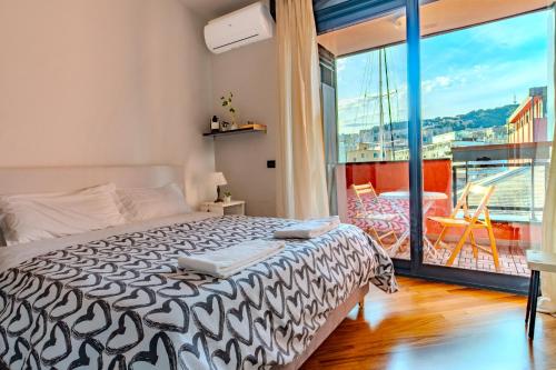 a bedroom with a large bed and a balcony at SOPRA il MARE con KATE in Genoa