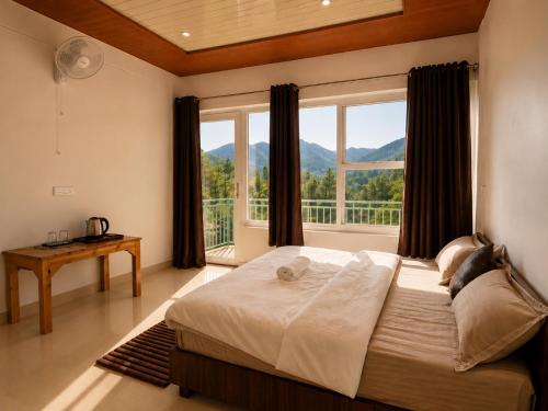 a bedroom with a large bed with a large window at Doi Stays Dak Bungalow in Almora