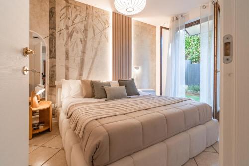 a large white bed in a room with a window at Luxury Garden Suite with Private Heated jacuzzi in Perugia
