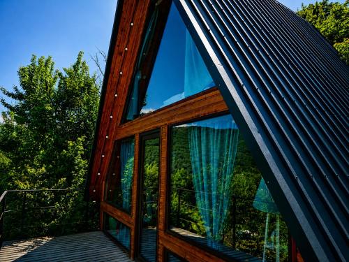 a house with a large window on a deck at Mtis qokhi Twins in Mtskheta