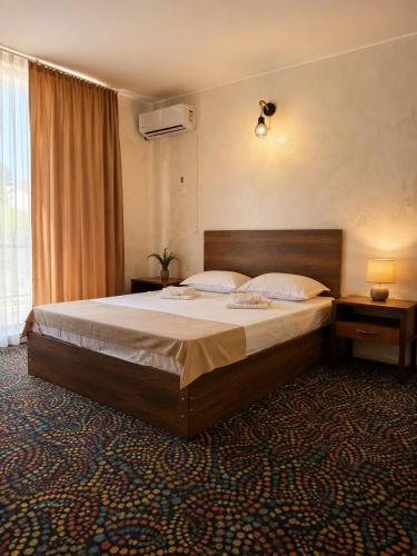 a bedroom with a large bed in a room at Hotel Kopala Ureki in Ureki