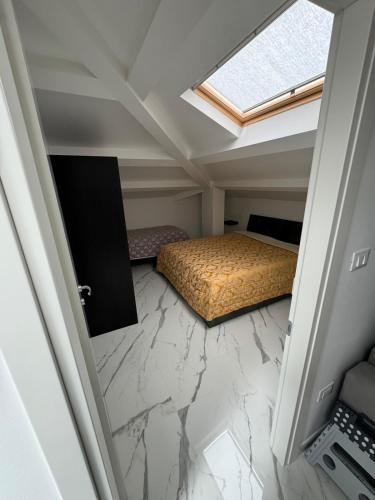 a bedroom with a bed and a skylight at Mansarda al mare in Tortoreto Lido