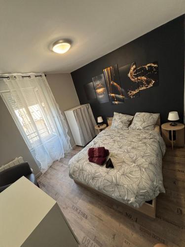 a bedroom with a large bed and a window at Le repos des sommets in La Bourboule