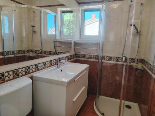 a bathroom with a sink and a shower and a toilet at sunny apartment in Bol