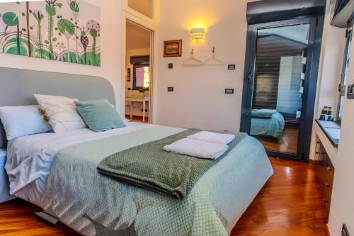a bedroom with a bed with two towels on it at Acquarium dream apartment kate in Genoa