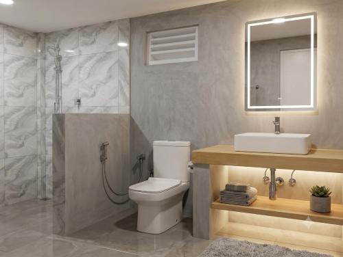 a bathroom with a toilet and a sink and a shower at Moon Garden Hotel And Restaurant in Arugam Bay
