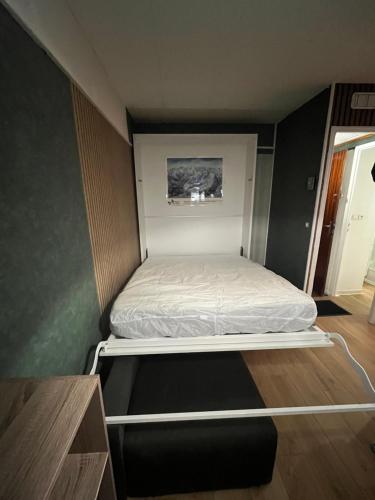 a small bedroom with a bed in a small room at Appartement pied ESF in La Toussuire