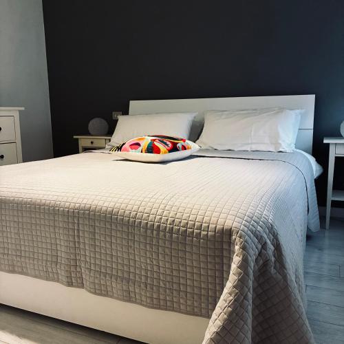 a bedroom with a large bed with a pillow on it at Pop Art Apartament in Treviso