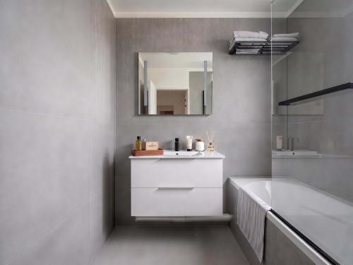 a bathroom with a sink and a mirror at Paris Bercy with car park by Melvane in Charenton-le-Pont