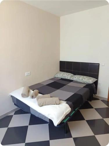 two beds in a room with a checkered floor at Piso Delfin Playa in Moncófar