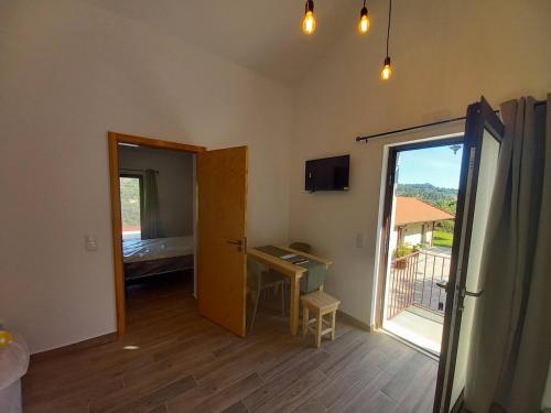 a room with a door open to a room with a balcony at Quinta Pedra do Rio - Penedo in Salvador do Monte