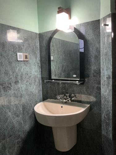 a bathroom with a sink and a mirror at Villa Sadalla in Hikkaduwa