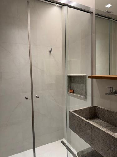 a shower with a glass door in a bathroom at Salinas Beach Resort in Salinópolis
