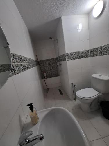 a bathroom with a white tub and a toilet at Dar Nour in Sousse