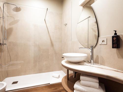 a bathroom with a sink and a shower at SOUL OF TRENTO San Martino in Trento
