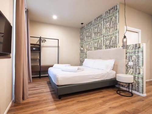 a bedroom with a bed with a large headboard at SOUL OF TRENTO San Martino in Trento