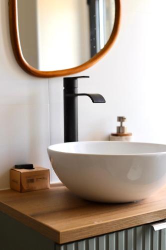 a bathroom with a sink and a mirror on a counter at Casa do Sol in Pedrógão