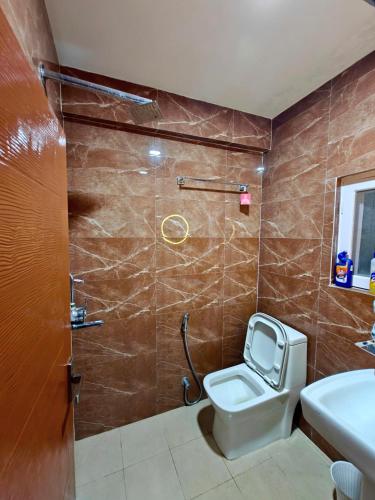 a bathroom with a toilet and a sink and a shower at Lalitpur stay in Pātan