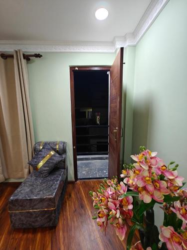 a living room with a couch and a plant at Lalitpur stay in Pātan