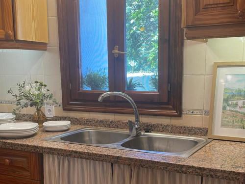 a kitchen counter with a sink and a window at La Huerta in Tacoronte