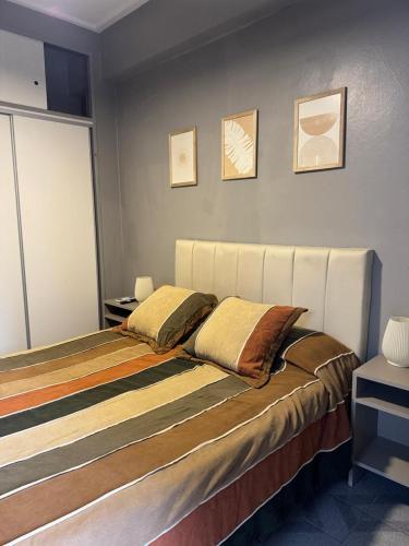 a bedroom with a bed with two pillows on it at Danella in San Miguel de Tucumán