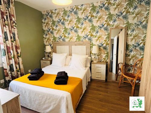 a bedroom with two beds and a yellow blanket at Bilbao La Vieja Arena WIFI in Bilbao