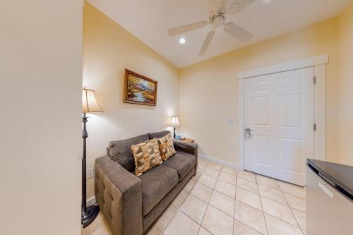 a living room with a couch and a ceiling fan at Efficient Getaway with Free WiFi - Close to Acadia National Park in Northeast Harbor