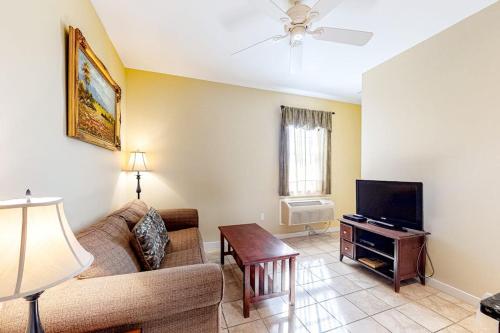 a living room with a couch and a tv at Two Neighboring Suites, Each w/ WiFi, Two TVs, and Central AC - Near Acadia in Northeast Harbor