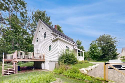 a white house with a porch and a deck at Charming Camden Retreat with Front Porch, Deck and Wifi in Camden