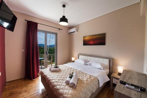 a bedroom with a bed and a large window at Magician's Apartments in Lefkada